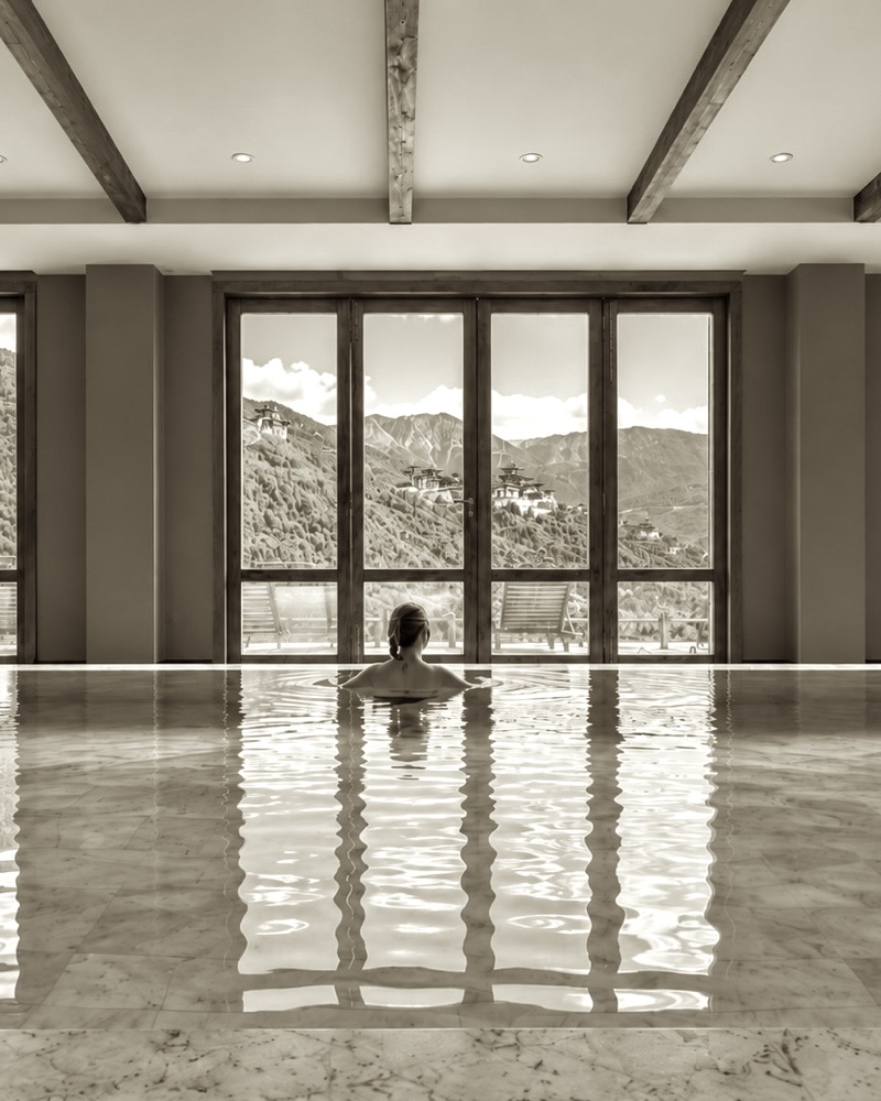Indoor pool with mountain views at a longevity retreat